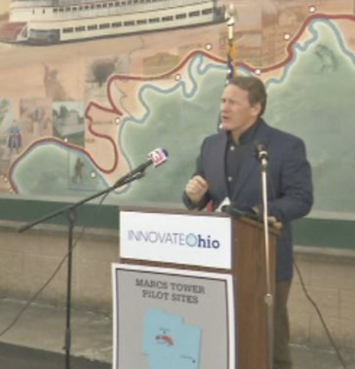 Jon Husted speaking outside.