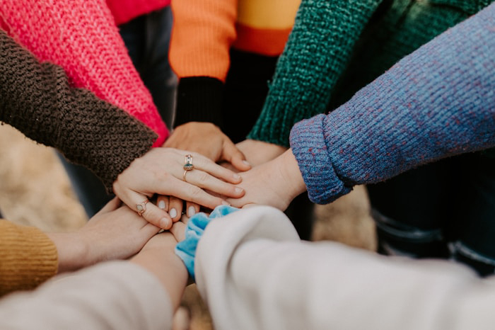 photo-1582213782179-e0d53f98f2ca hands together in a circle.