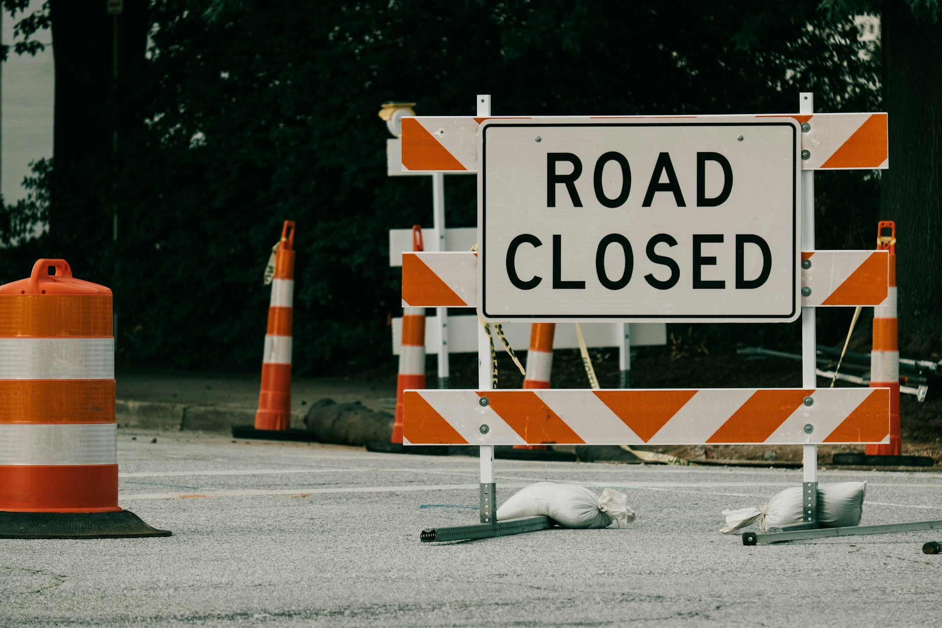 Road Closed sign and orange cones.